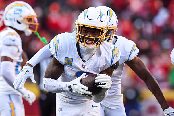 Derwin James Jr. leaping to intercept the ball against Travis Kelce